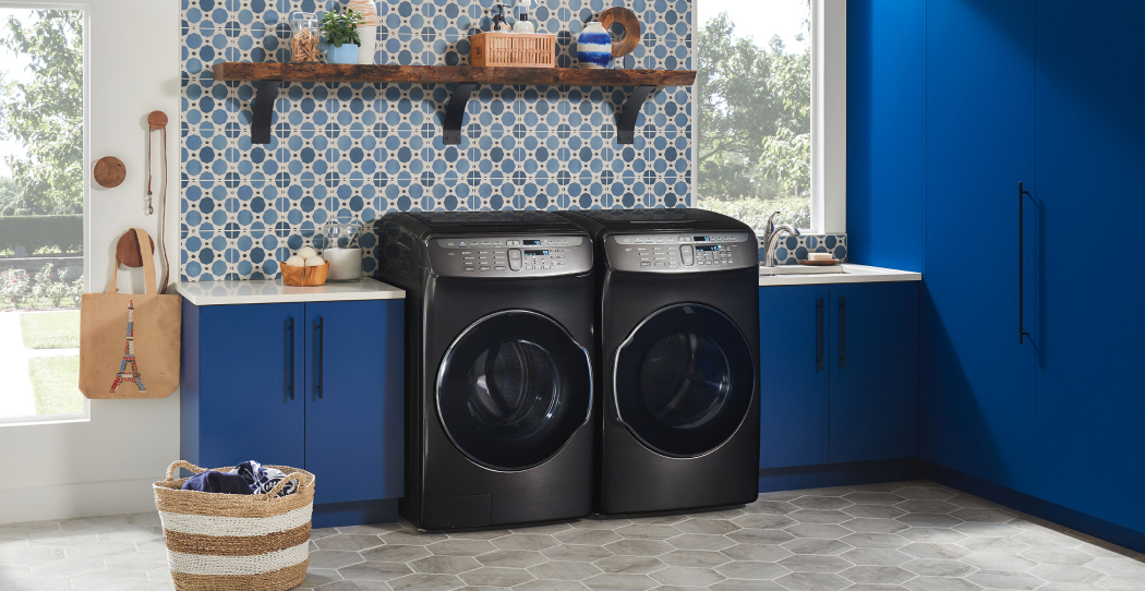 a set of black washer and dryer in a colorful laundry room